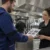 Tecnico AirBio consegna il certificato di pulizia della cappa con rapporto fotografico alla titolare di un ristorante